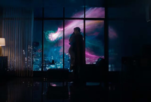 Superman and Lois embracing by a window as purple lights dominate the sky outside