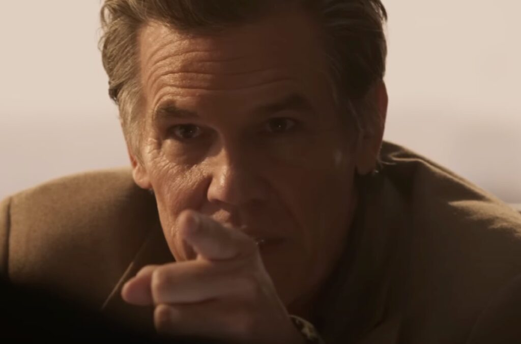 Close-up of a tough-looking man pointing.