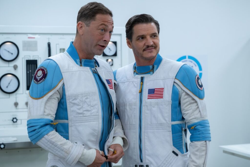 Two characters in space suits in a laboratory setting.